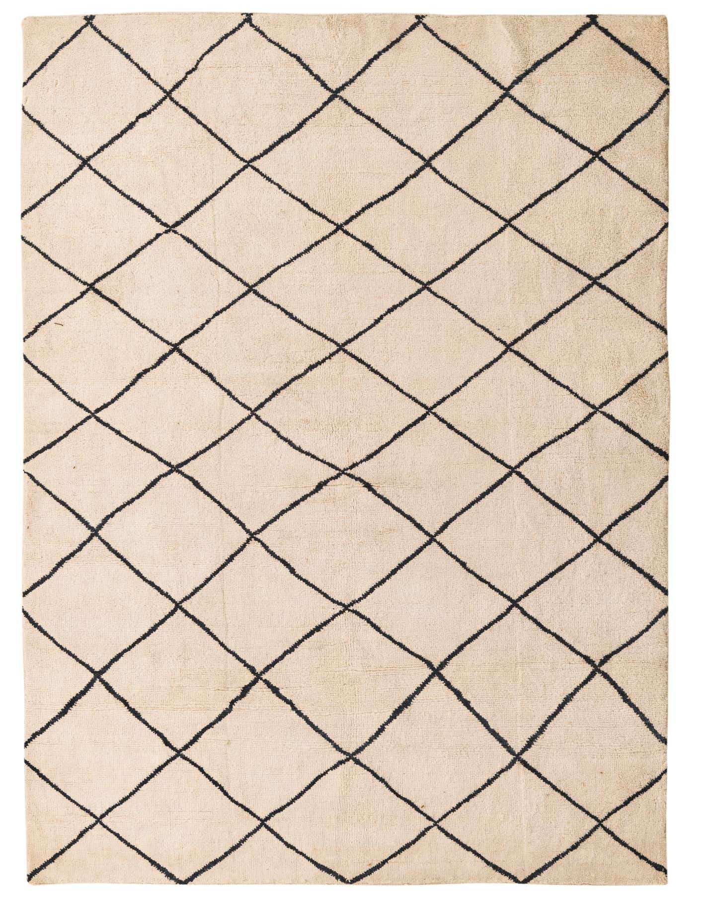 A 5x8 rectangular ivory shag rug with a black tribal diamond pattern, ideal for a living room.