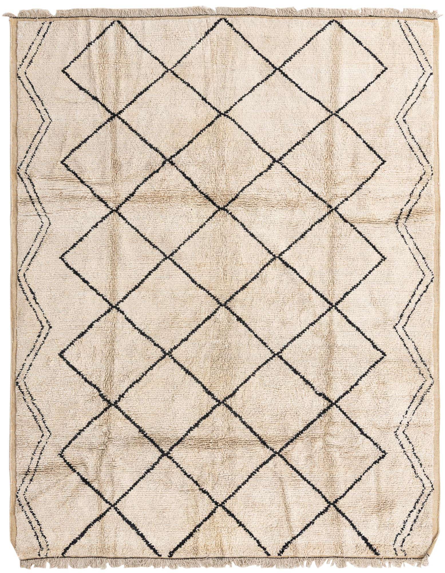 A 7x10 rectangular ivory shag rug with a black tribal diamond pattern and fringe edges, suitable for a living room.