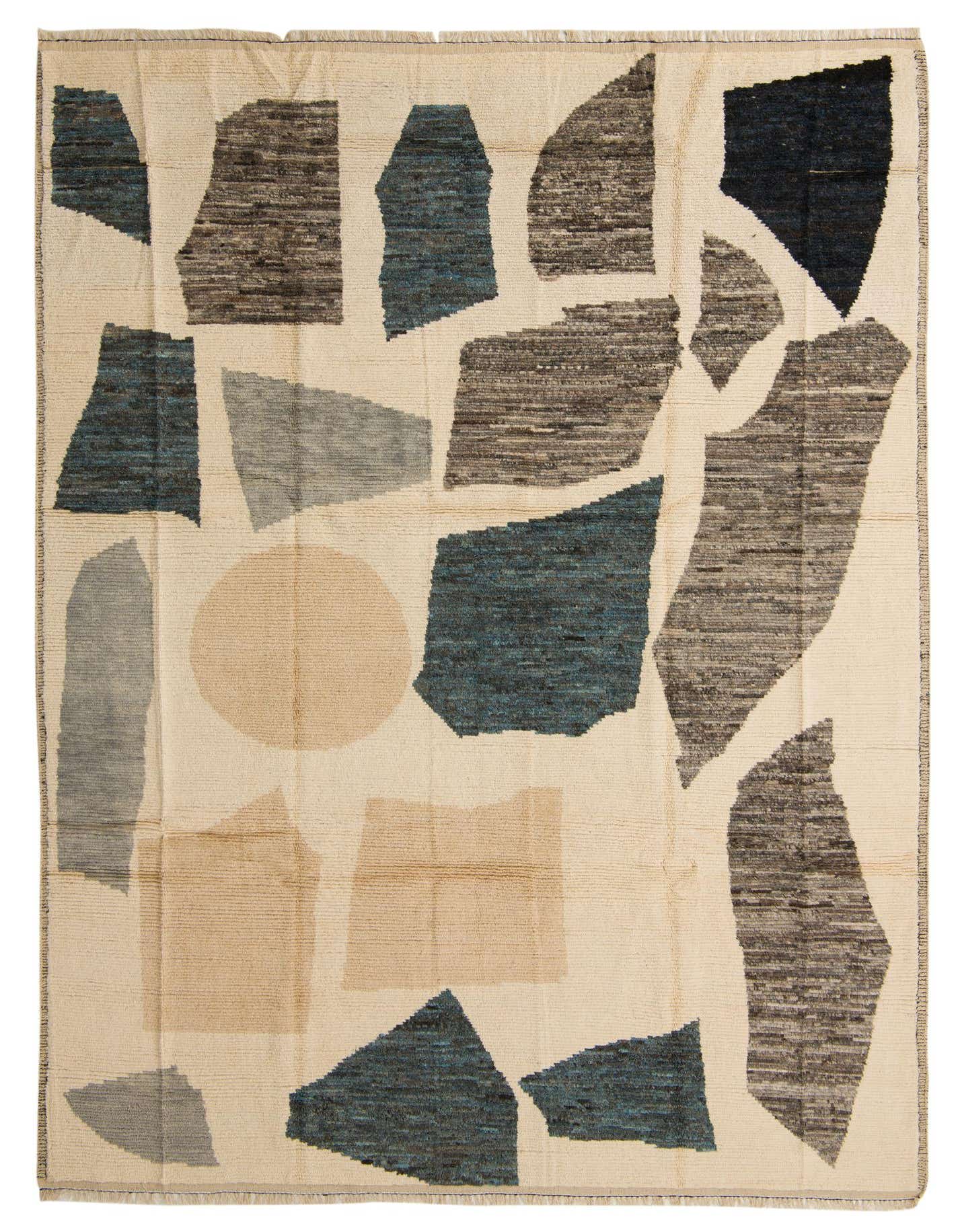 A 9x12 rectangular ivory wool shag rug with an abstract tribal pattern in shades of blue, gray, and brown.