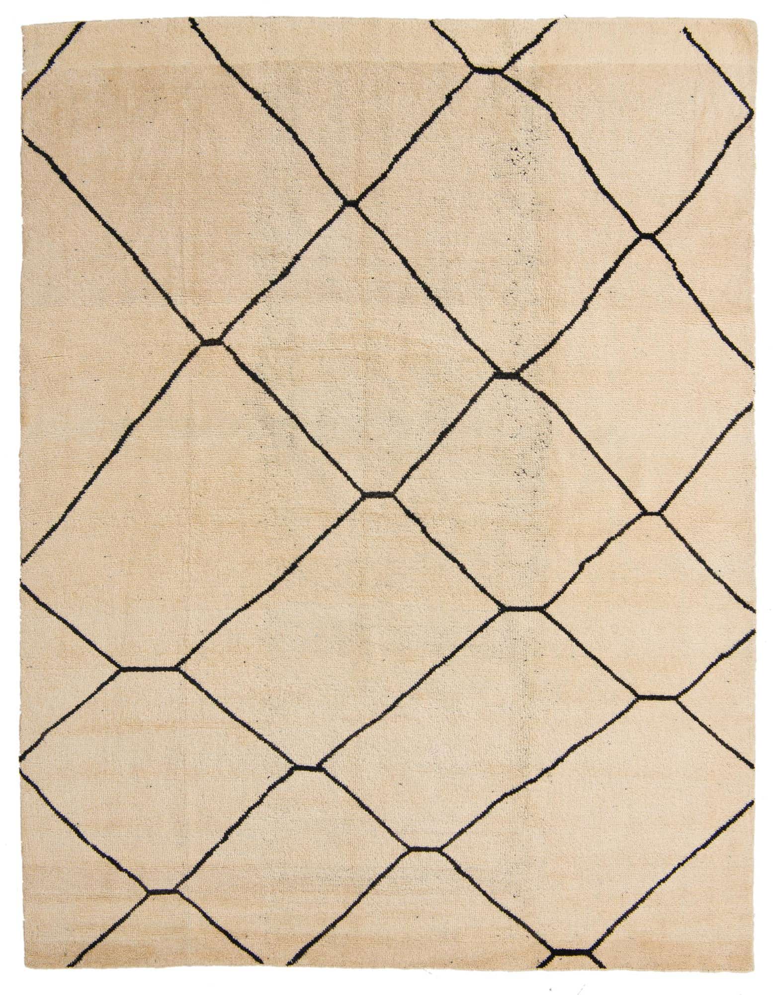 An 8x10 rectangular ivory shag rug with a bold black tribal geometric diamond pattern, suitable for a living room.