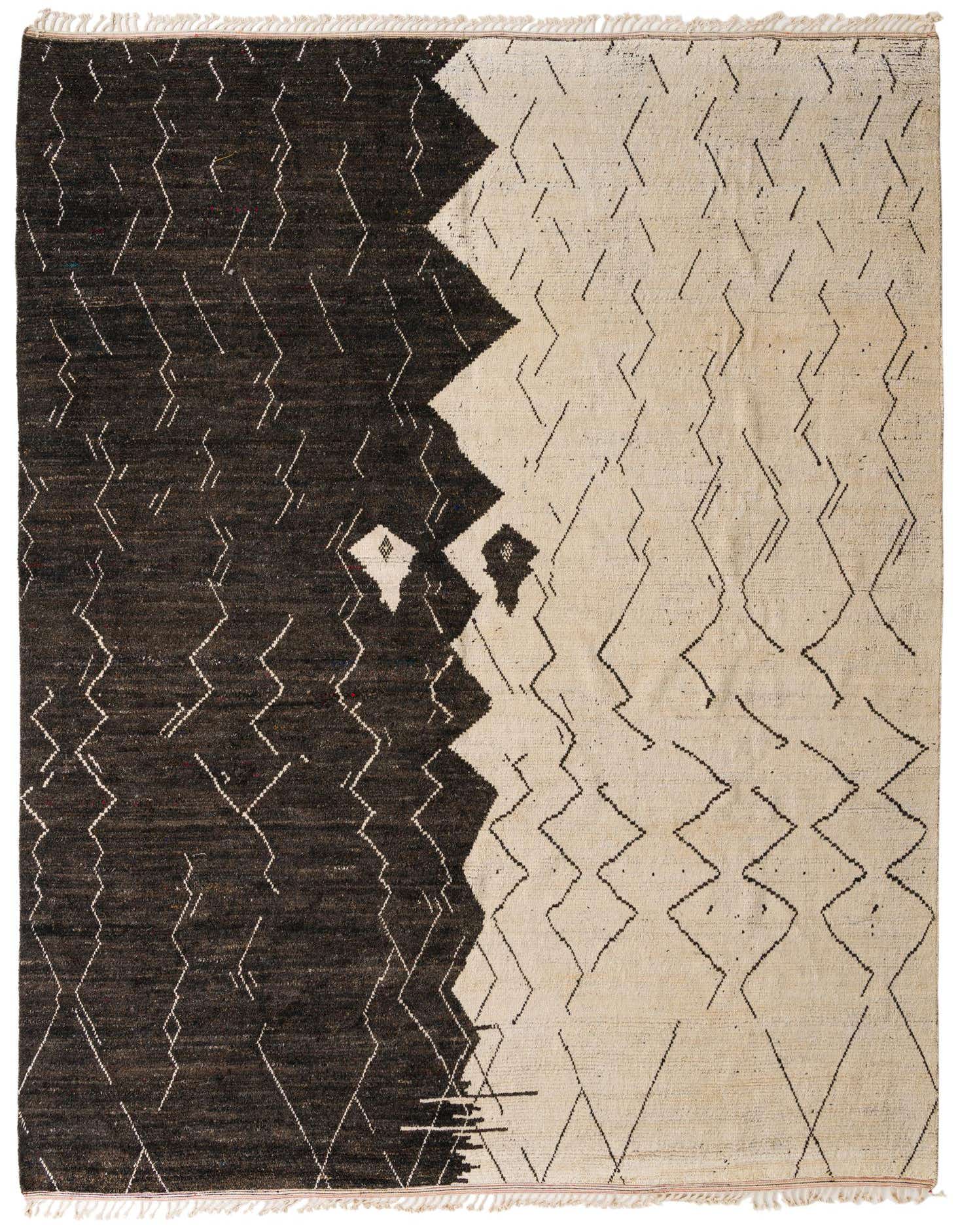 A large 12x16 rectangular Moroccan shag rug with a bold black and ivory tribal abstract pattern, handmade from wool.