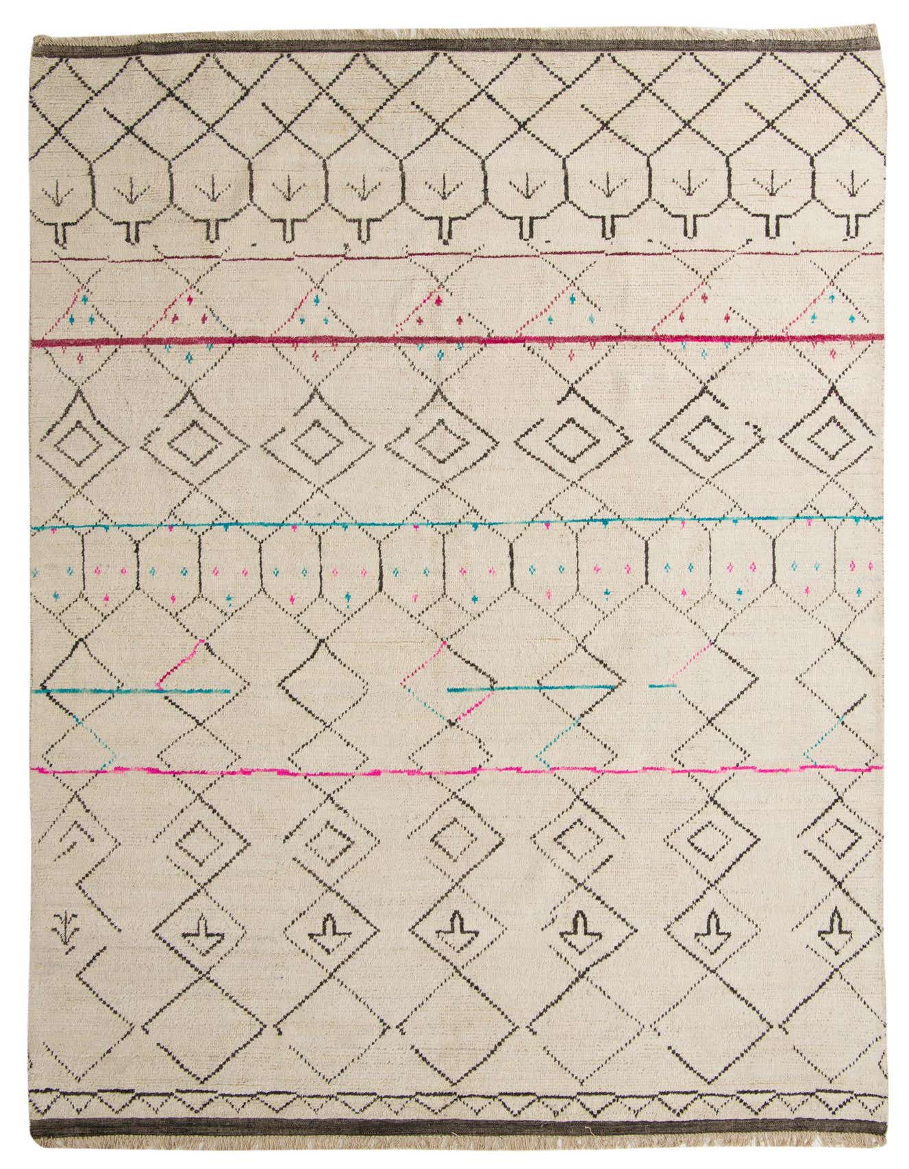 A 10x16 rectangular ivory wool shag rug with a modern tribal pattern featuring black geometric shapes and thin pink and blue accent lines.