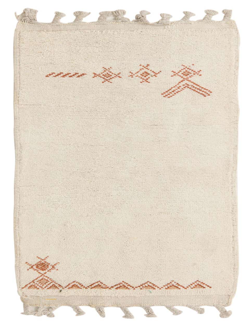 A 3x5 rectangular ivory shag rug with subtle burnt orange tribal patterns and decorative tassels.