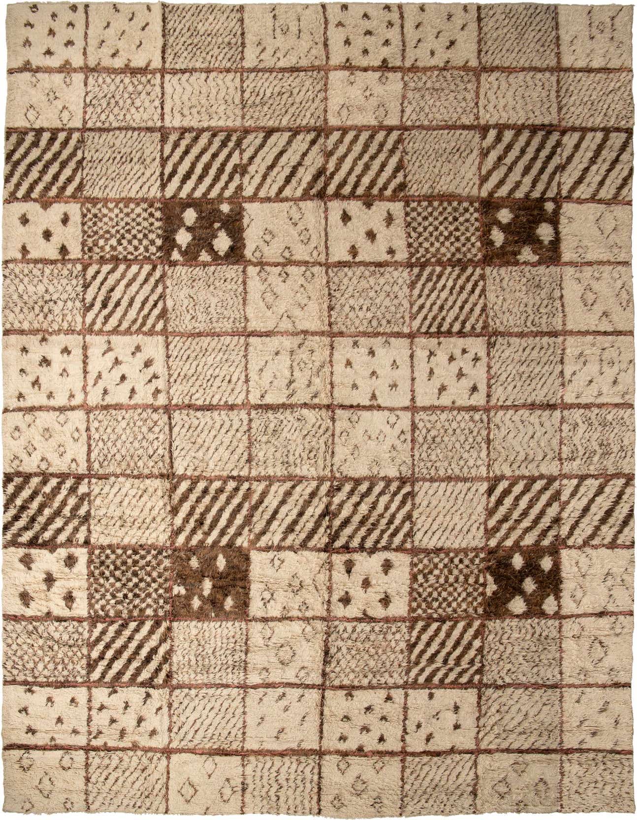 Rectangular ivory shag rug with a grid pattern of brown tribal and abstract designs, suitable for a living room.