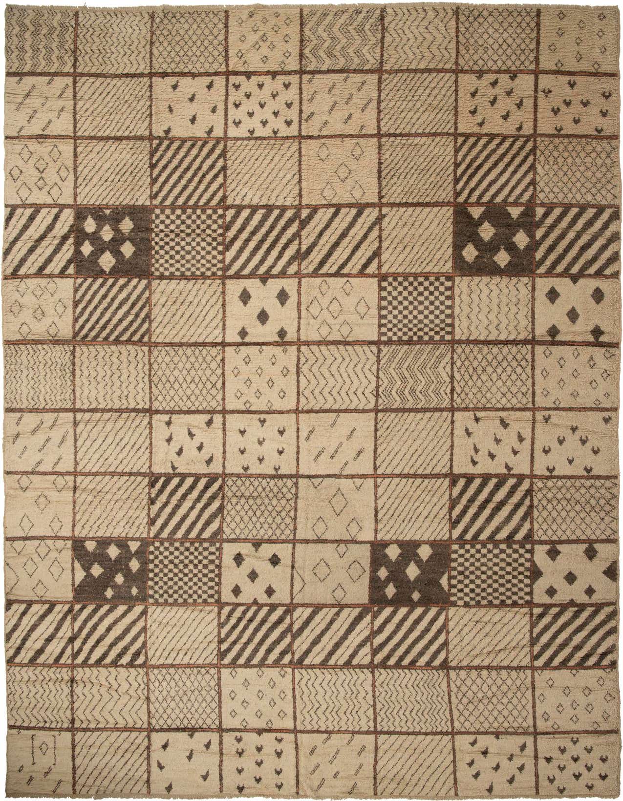 A large rectangular ivory and brown tribal shag rug with a patchwork of geometric patterns.