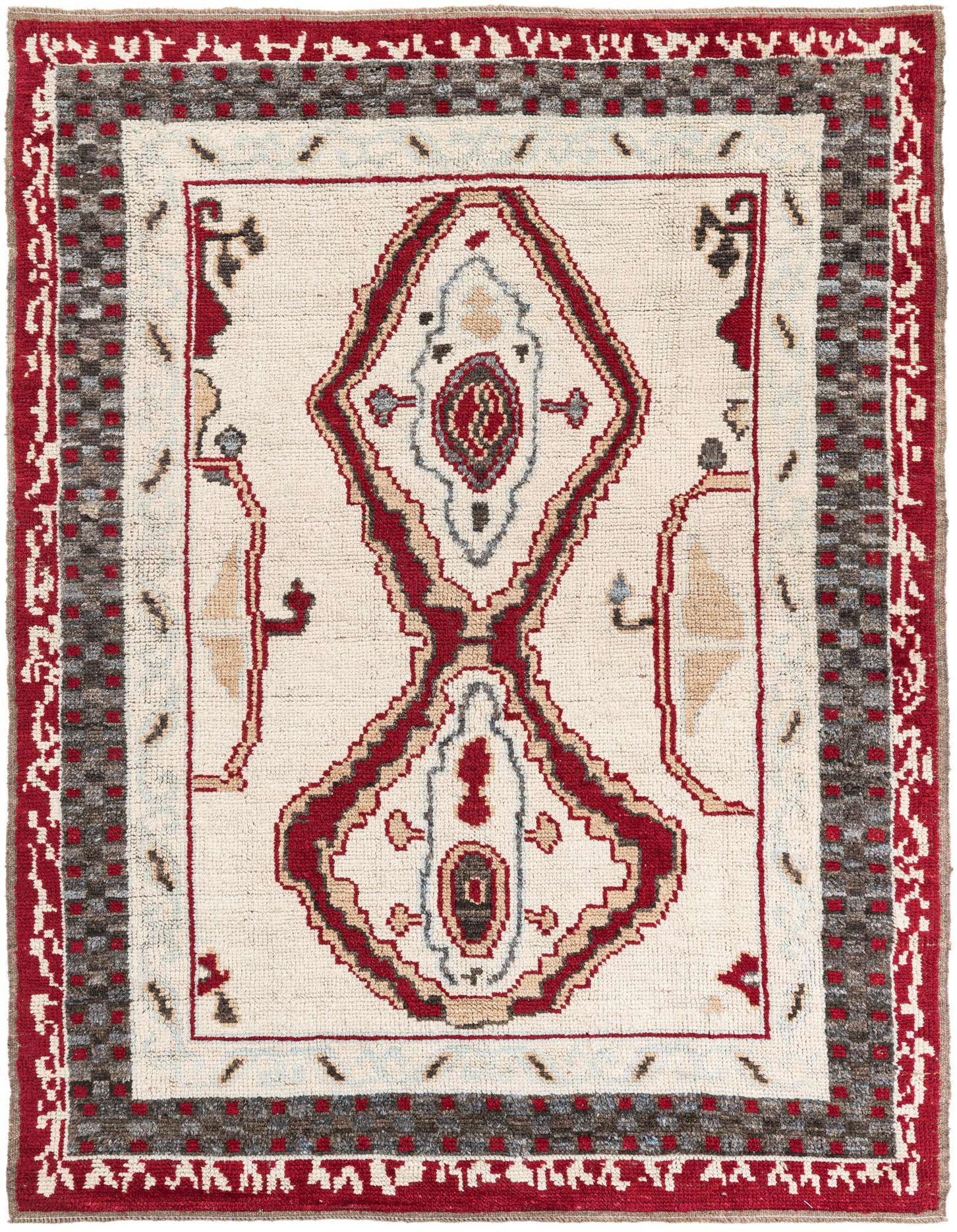 A 6x9 rectangular ivory wool shag rug with a red and gray tribal medallion pattern, ideal for a living room.