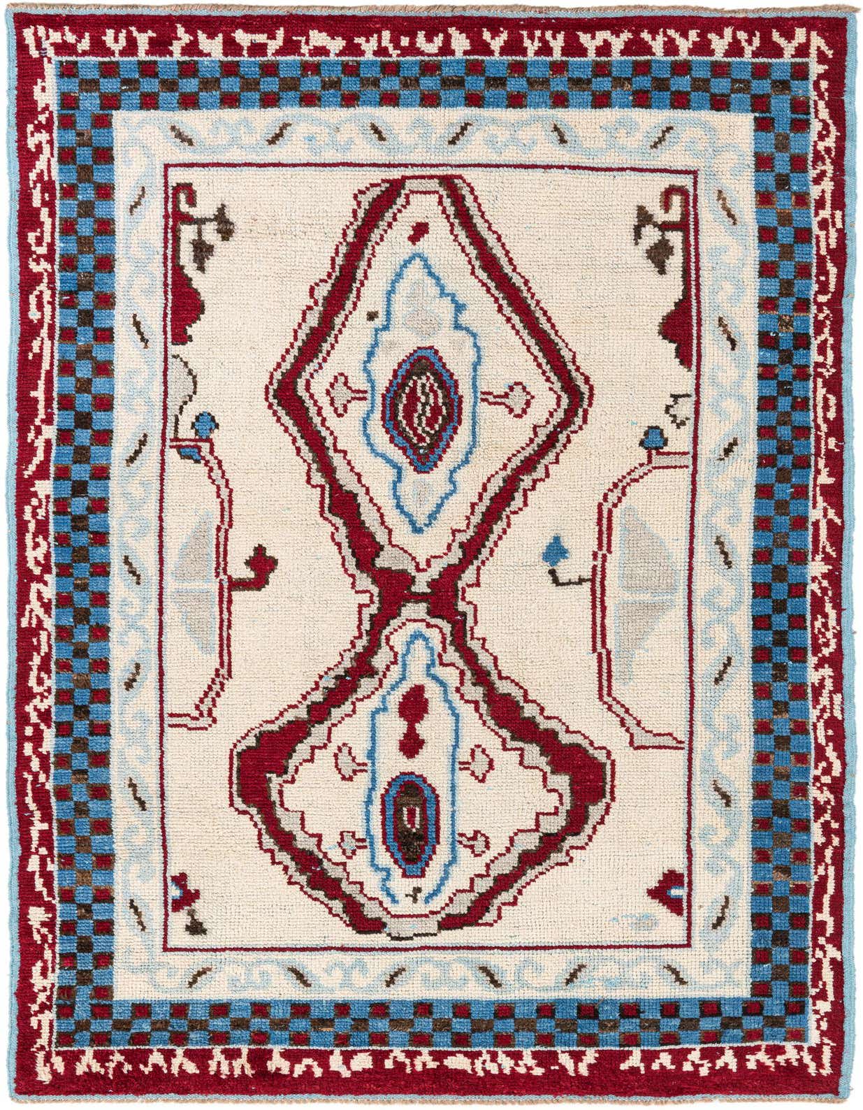 A 6x9 rectangular ivory wool shag rug with a red and blue tribal medallion pattern, ideal for a living room.