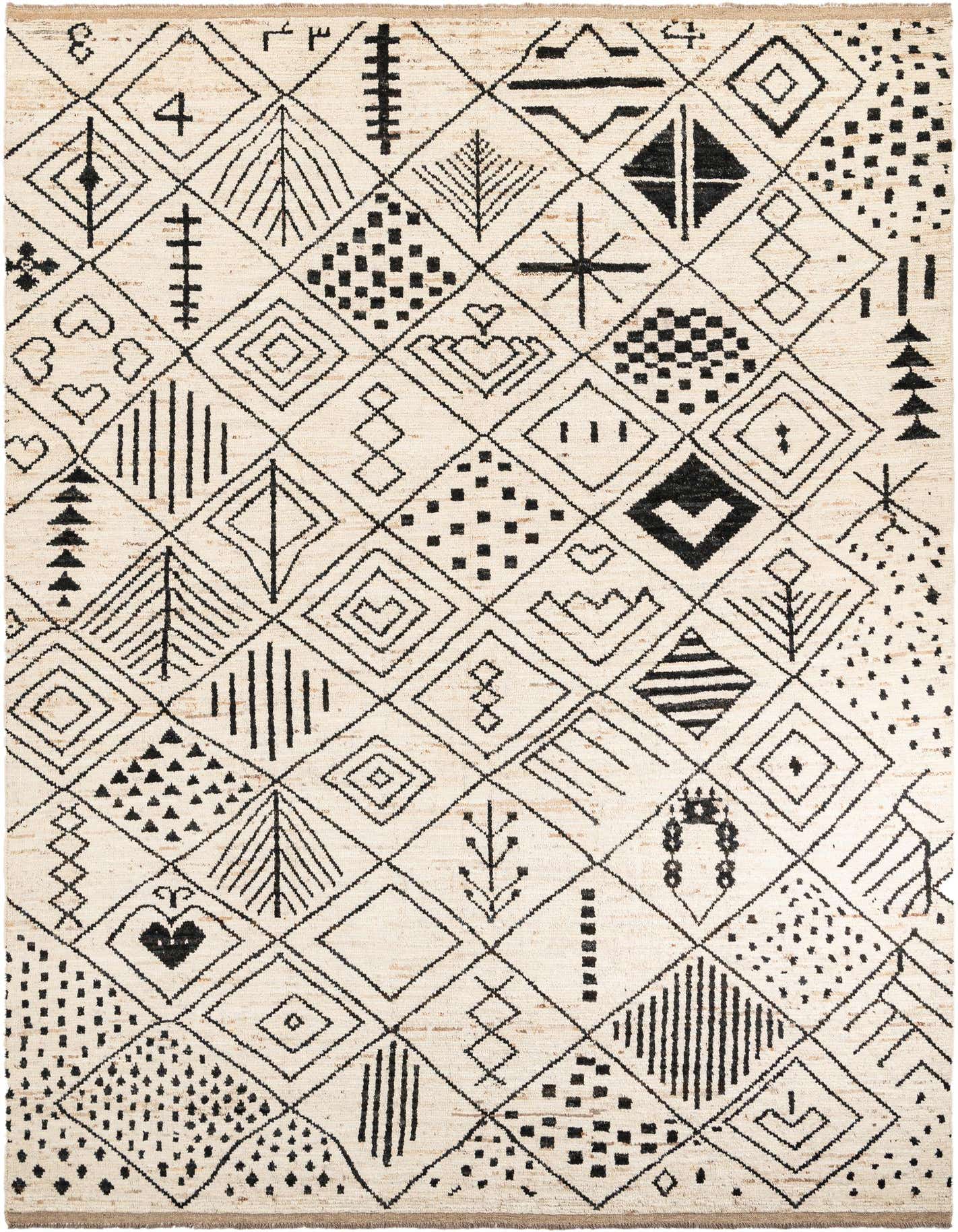 A 10x14 rectangular ivory wool shag rug featuring a modern tribal pattern with black geometric shapes and lines.