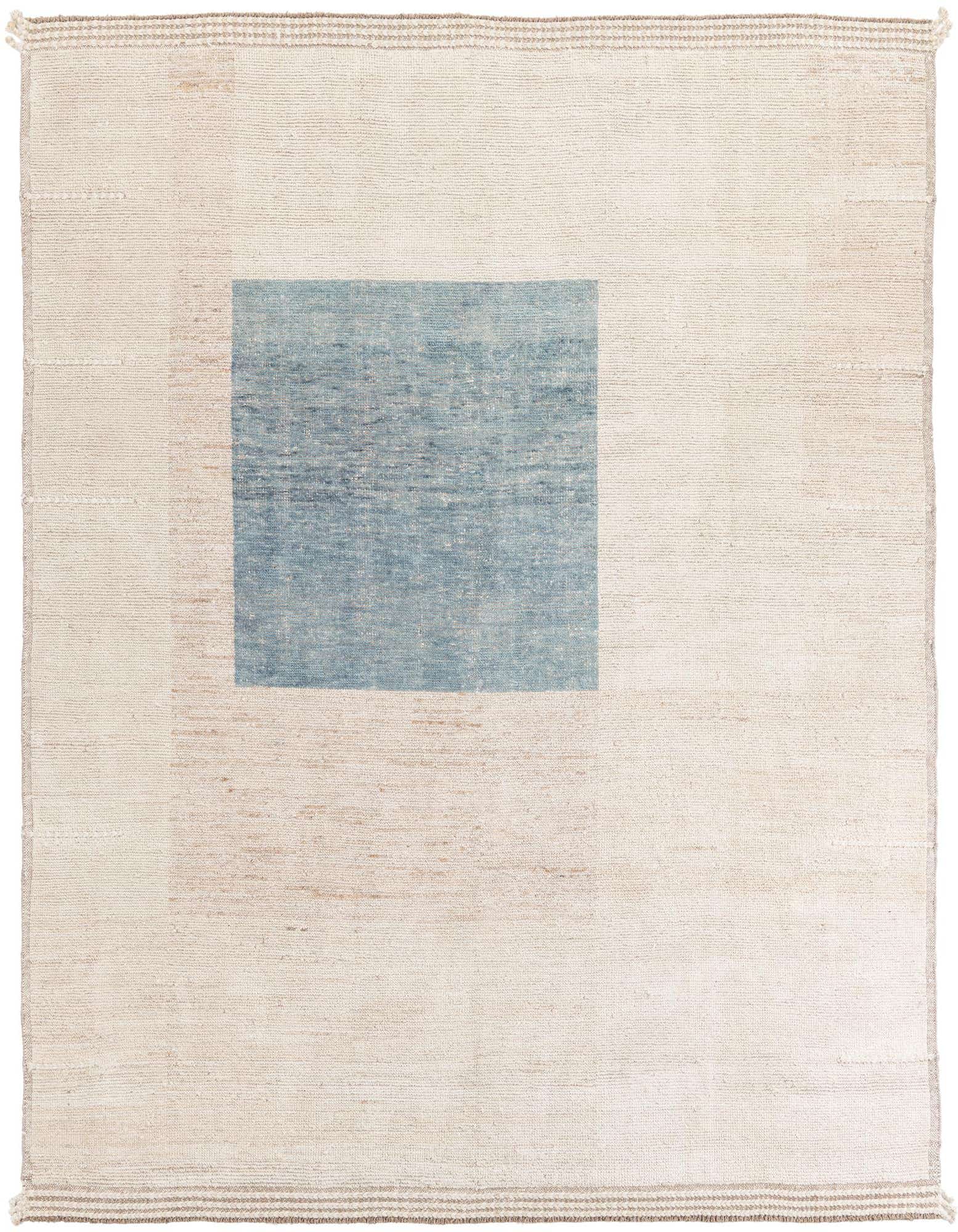 A rectangular 8x10 ivory shag rug with a single large light blue square in the upper left quadrant, showcasing a modern tribal design.