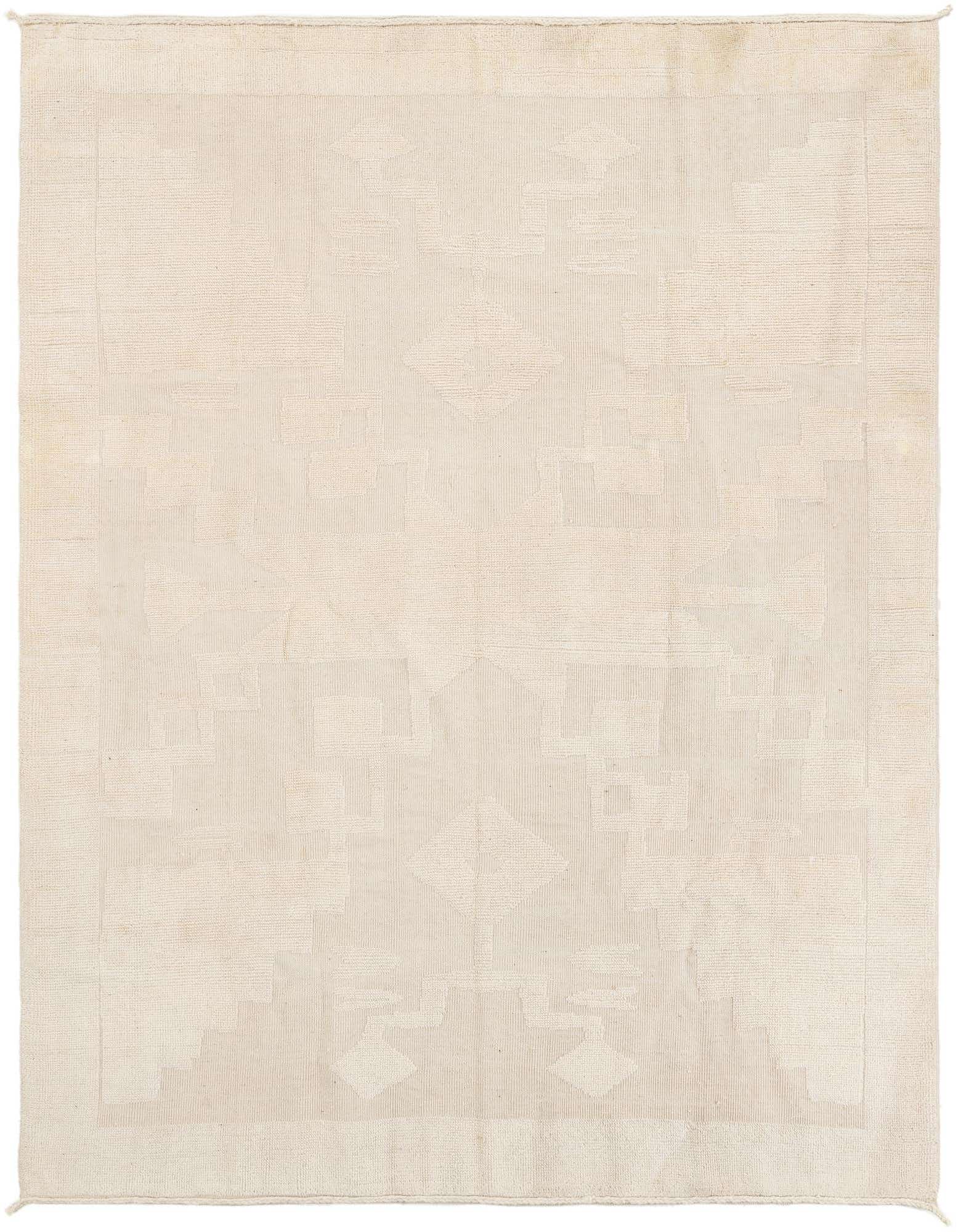 An 8x10 rectangular ivory wool shag rug with a subtle tribal abstract pattern, ideal for a living room.