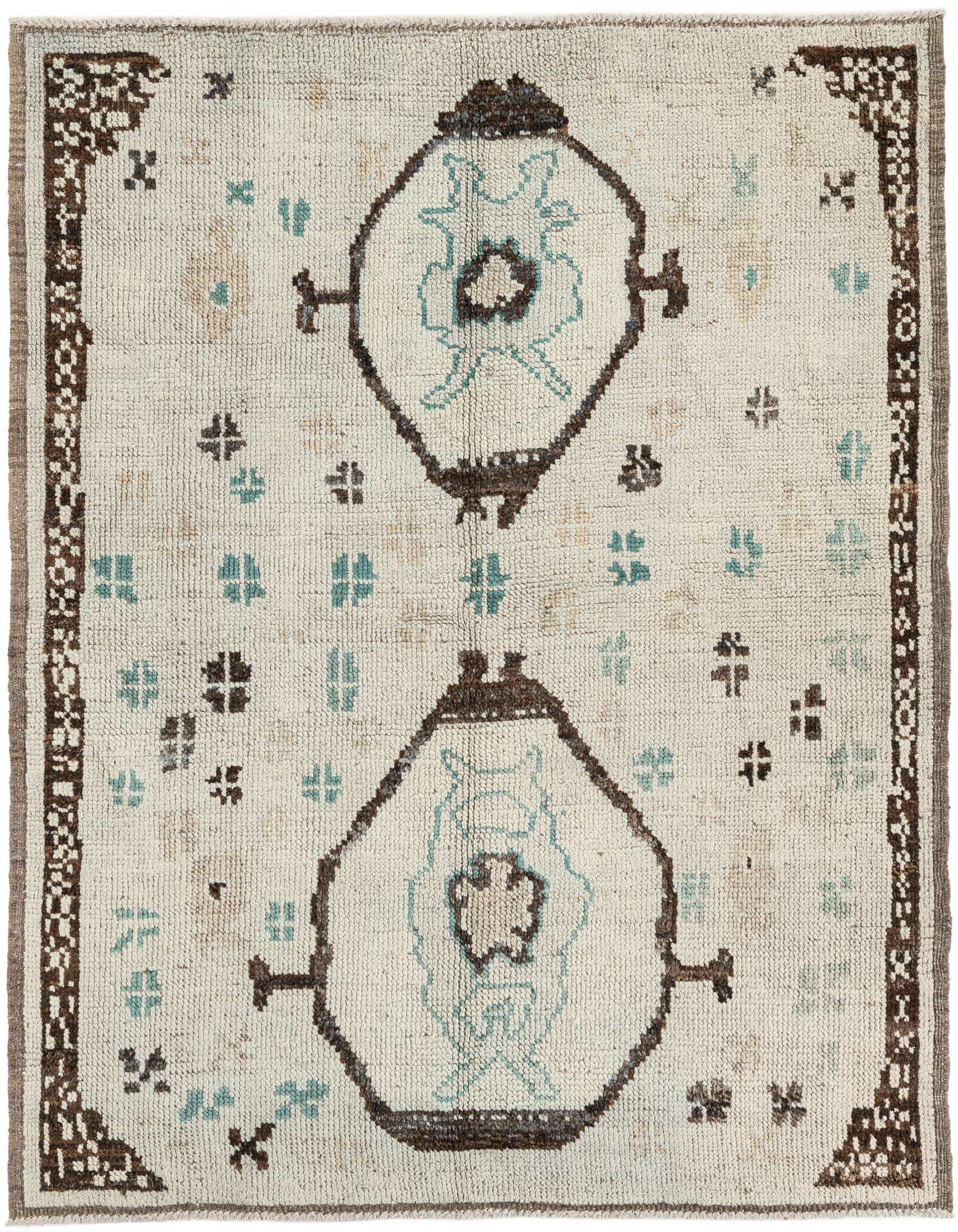 A 5x8 rectangular ivory wool shag rug with a tribal medallion pattern in brown and light blue, perfect for a living room.