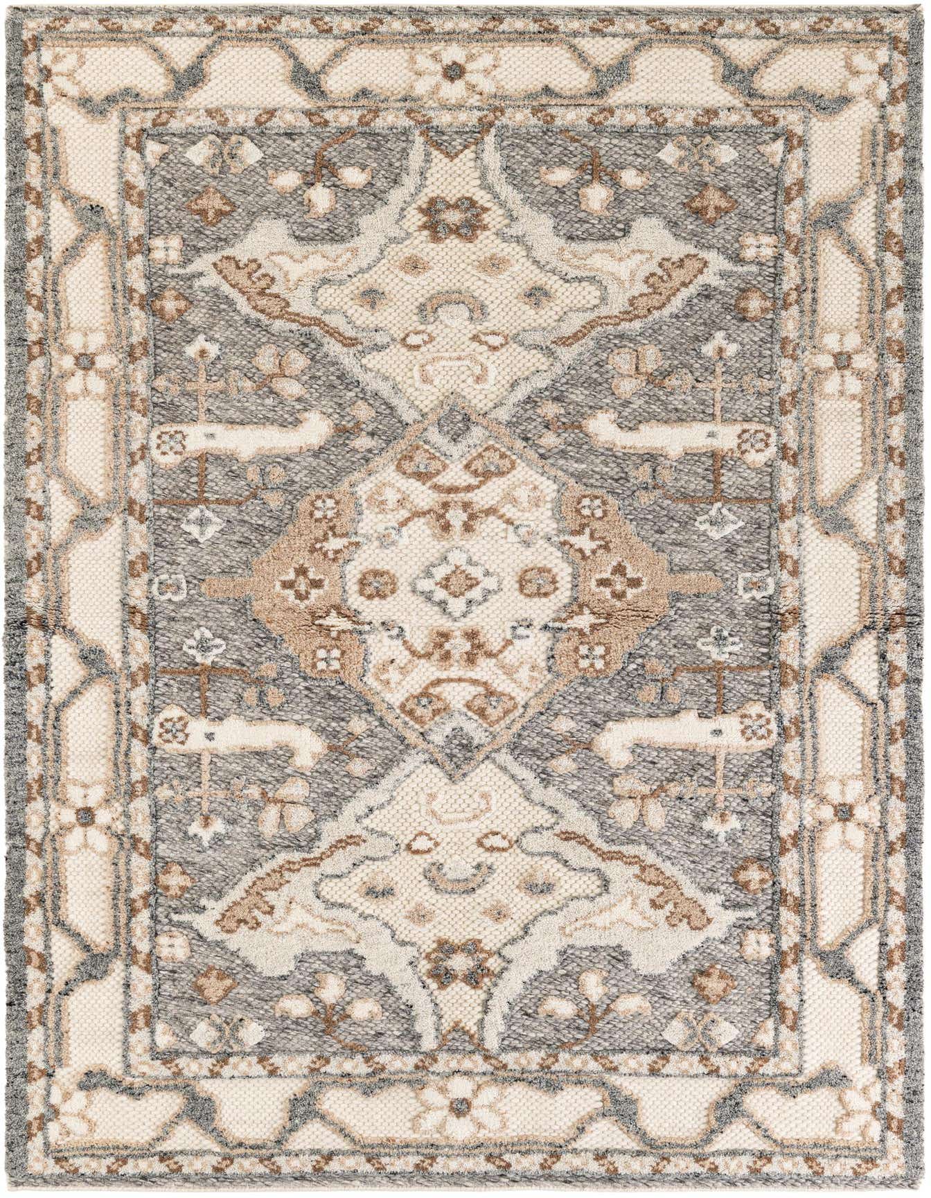 A 5x8 rectangular ivory and gray wool shag rug with a tribal medallion pattern, ideal for a living room.