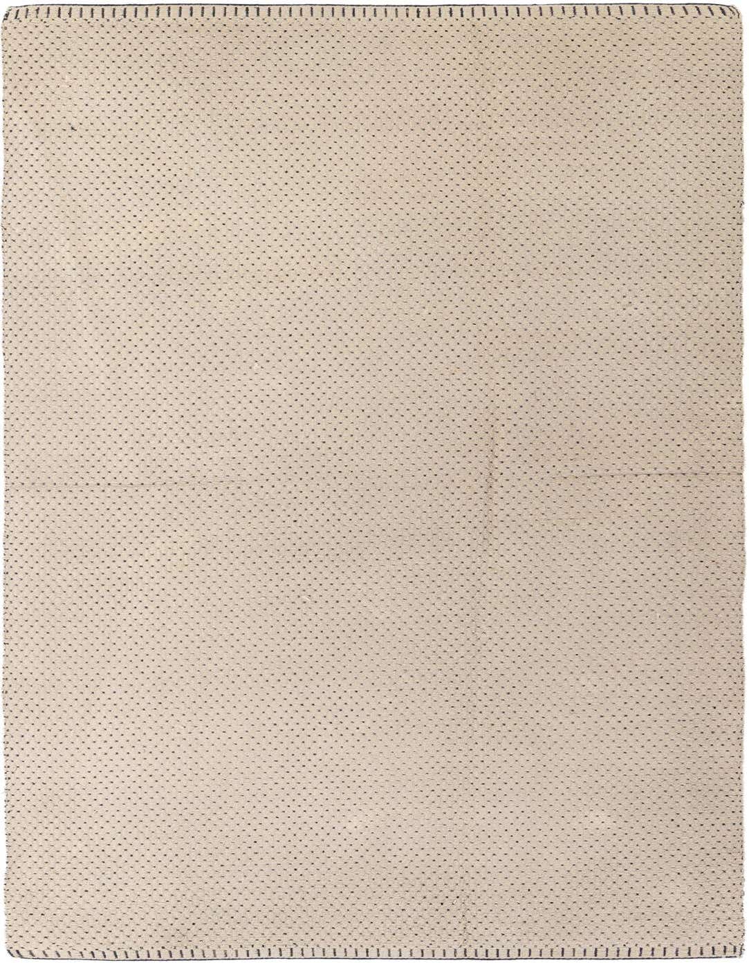 A 5x8 rectangular ivory shag rug with a subtle tribal dot pattern, perfect for a living room.