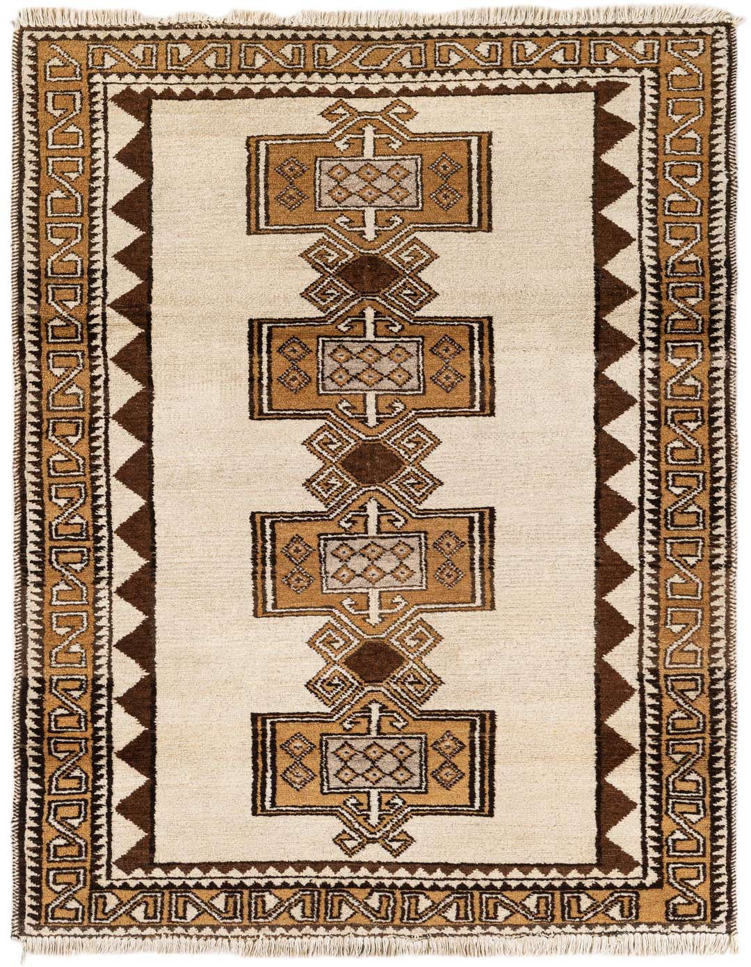 A 4x6 rectangular ivory wool shag rug featuring a central column of brown and tan tribal geometric patterns, perfect for a living room.