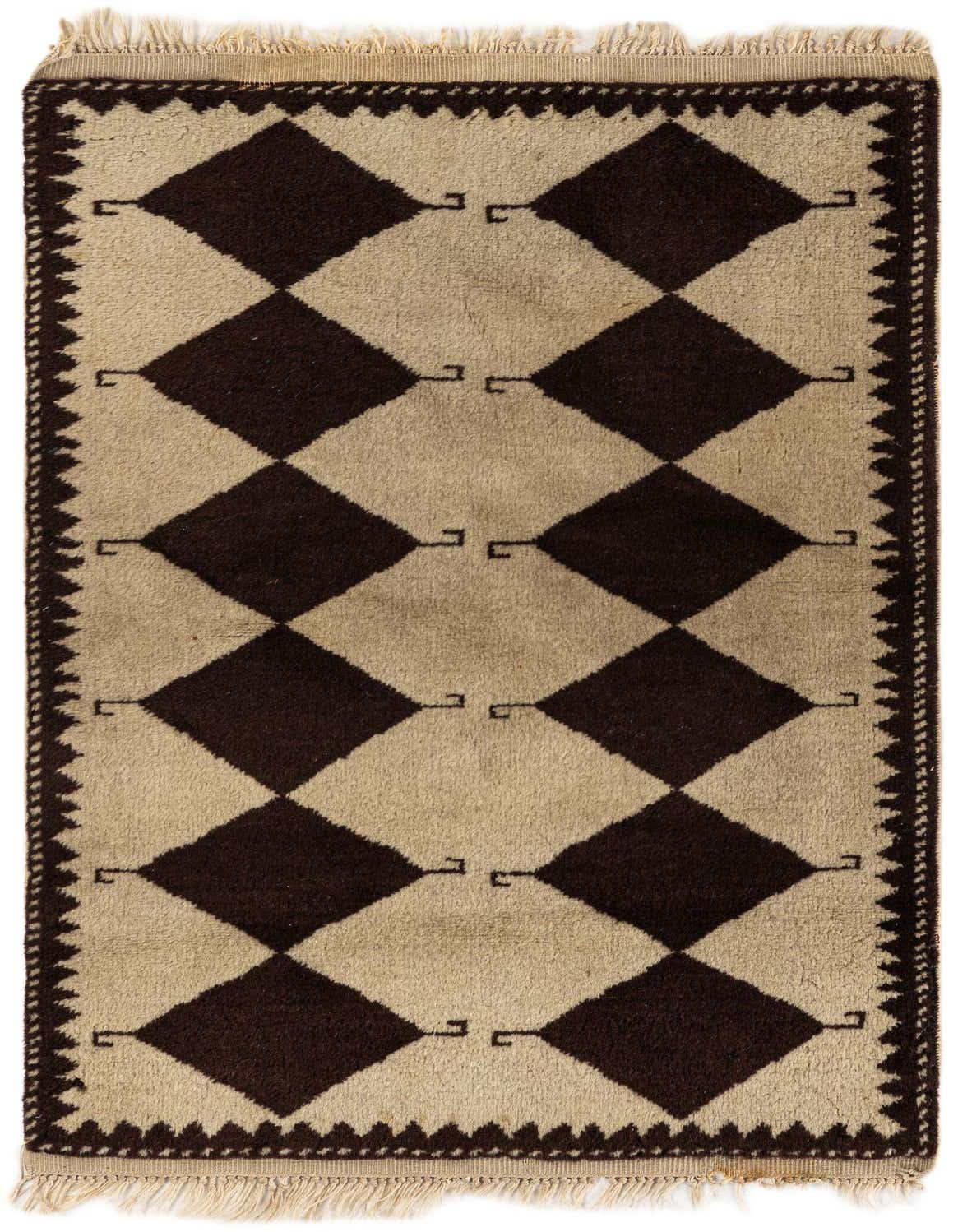 A 3x4 rectangular Moroccan shag rug with a bold tribal diamond pattern in ivory and dark brown, featuring fringe.