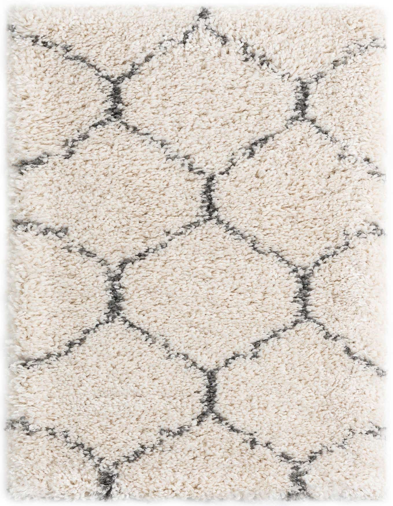 A soft, rectangular 2x3 ivory shag rug with a modern charcoal trellis pattern, ideal for adding comfort to any indoor space.