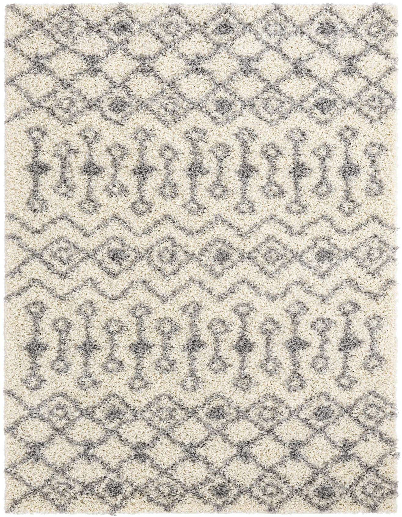 A 5x8 rectangular ivory shag rug with a modern tribal pattern in shades of gray, offering soft texture.