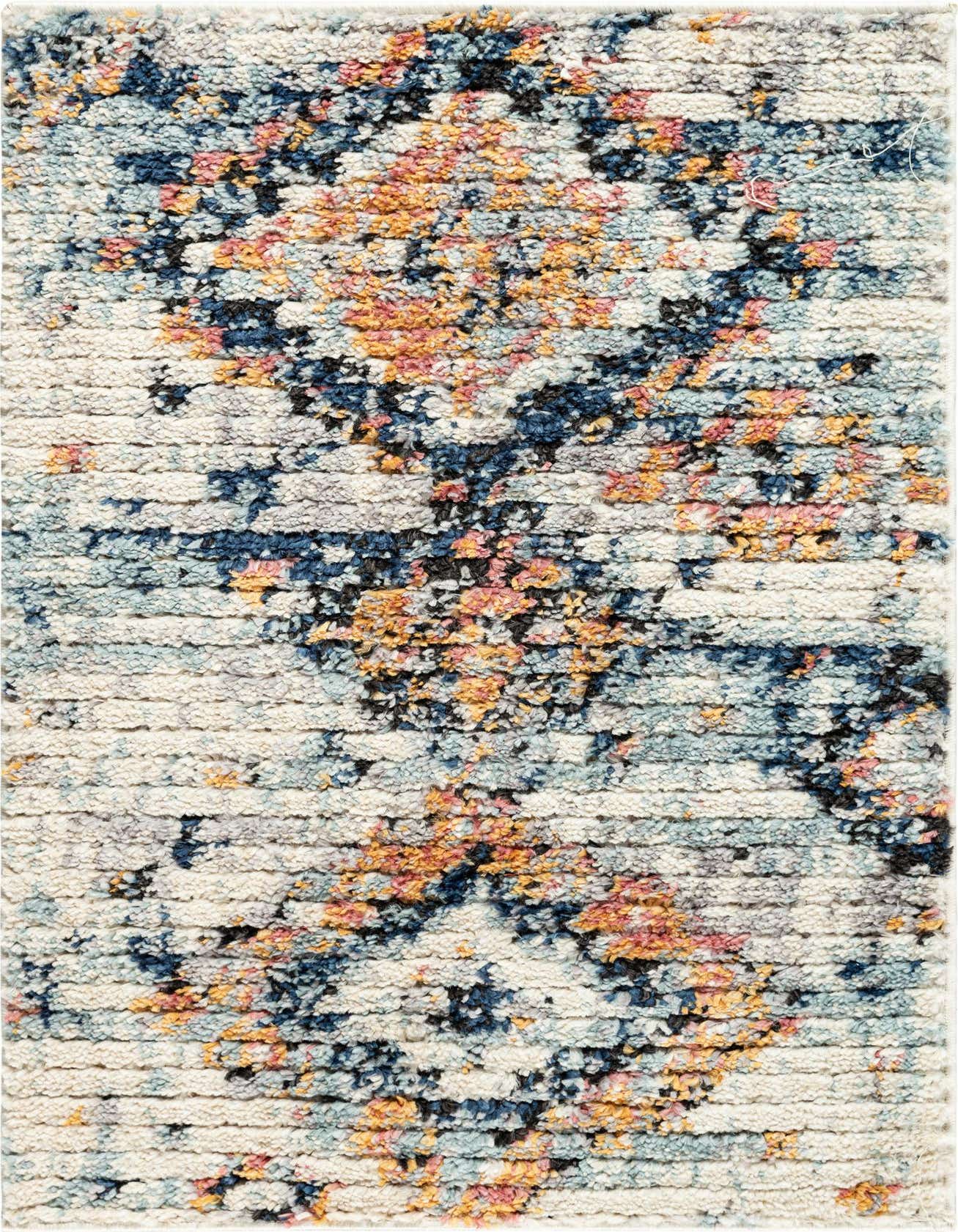 A close-up of a rectangular 2x3 ivory shag rug with a textured bohemian pattern in blue, orange, pink, and black.