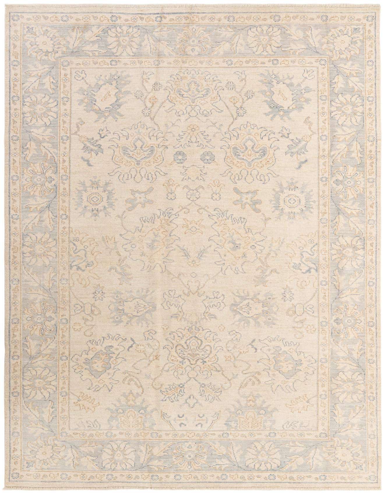 A 6x9 rectangular Oushak rug in ivory and cream with a subtle floral and vine pattern and a light blue border.