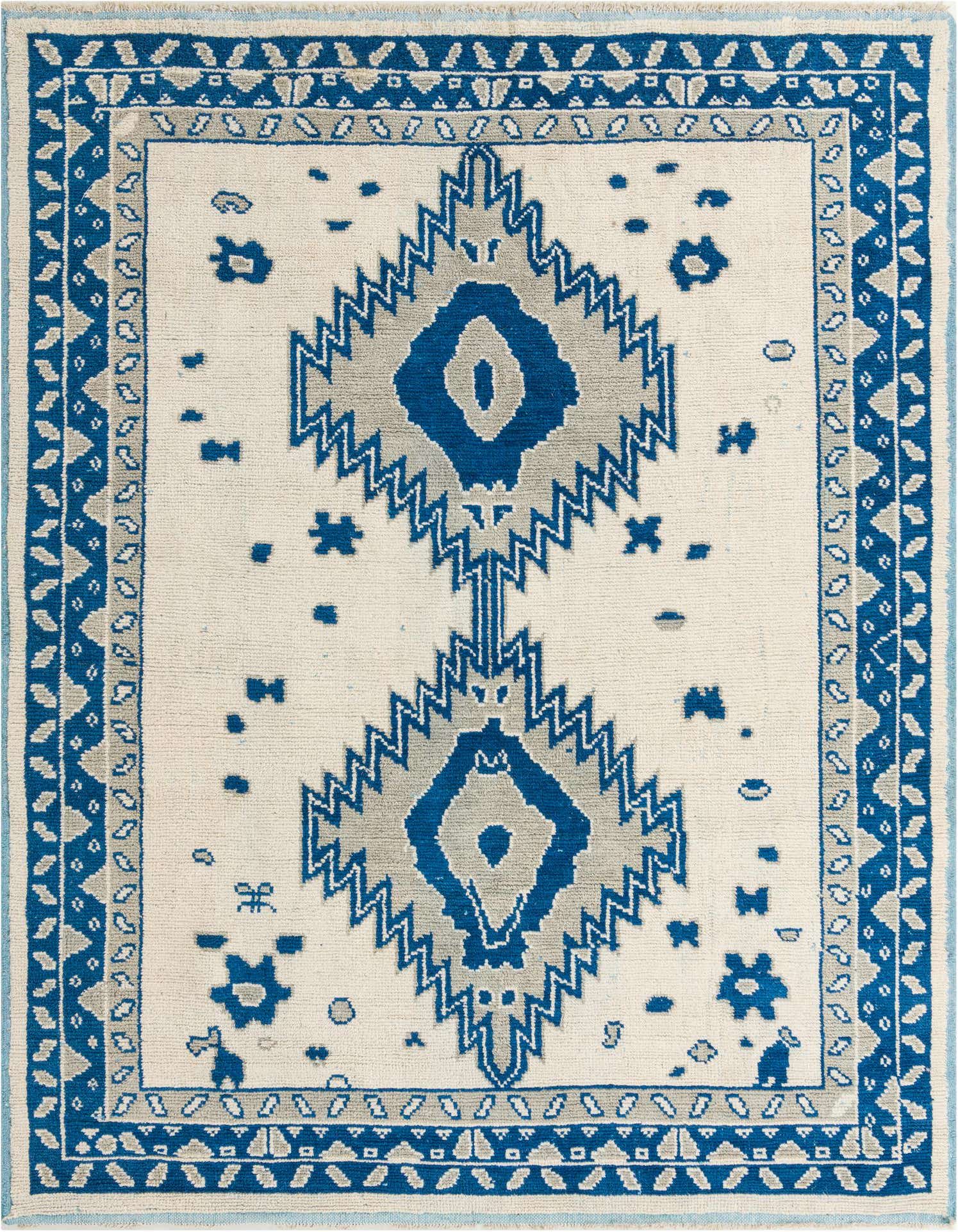 An 8x11 rectangular ivory wool rug with a bold abstract design in blue and gray, featuring two large central diamond motifs and a detailed border, suitable for a living room.