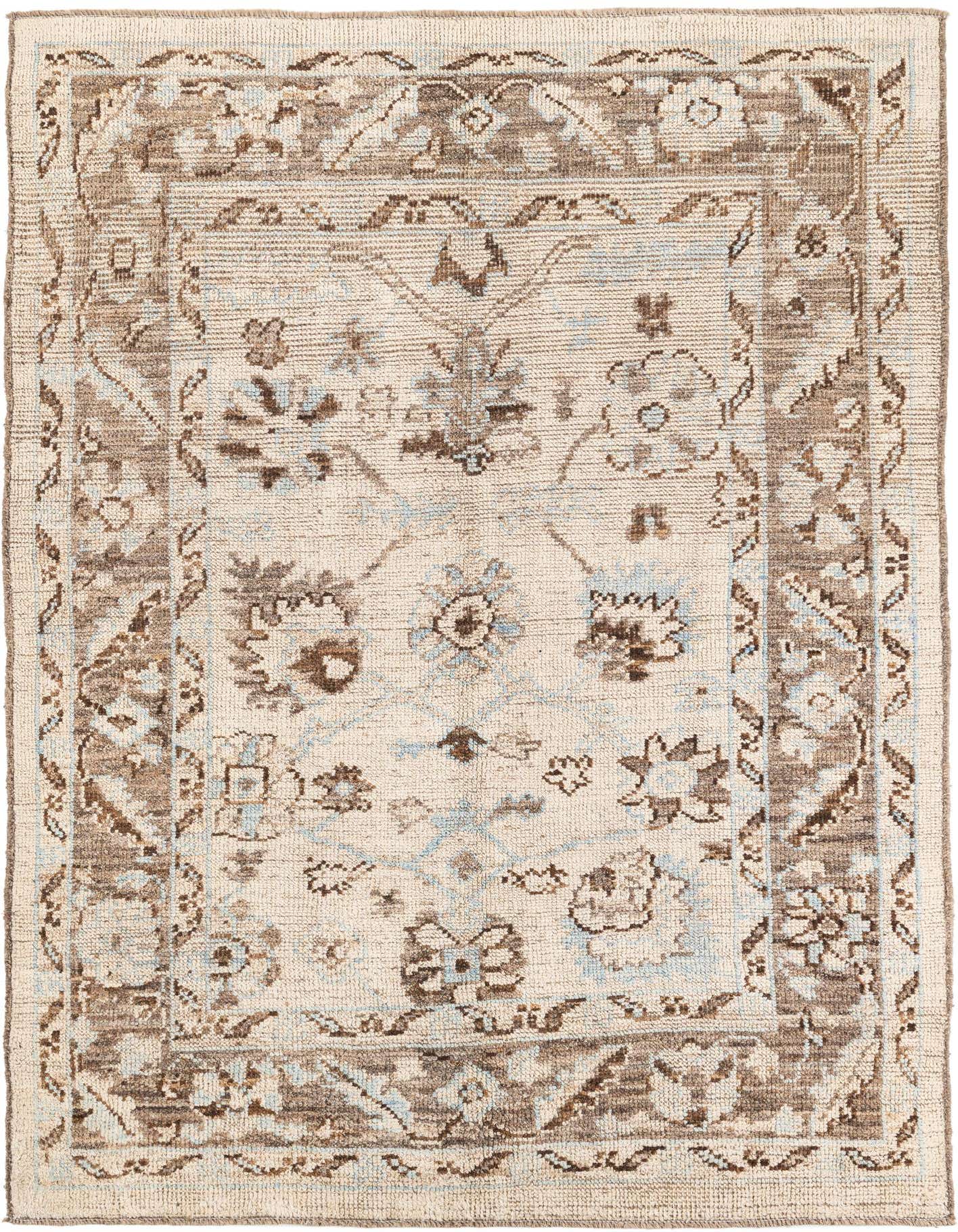 A 6x9 rectangular ivory and cream wool rug with a subtle modern Oushak pattern and brown and light blue accents.