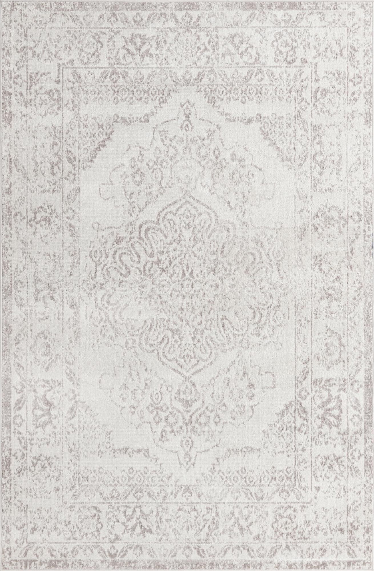 A 6x9 rectangular ivory and cream traditional rug with a subtle vintage medallion pattern, ideal for a living room.