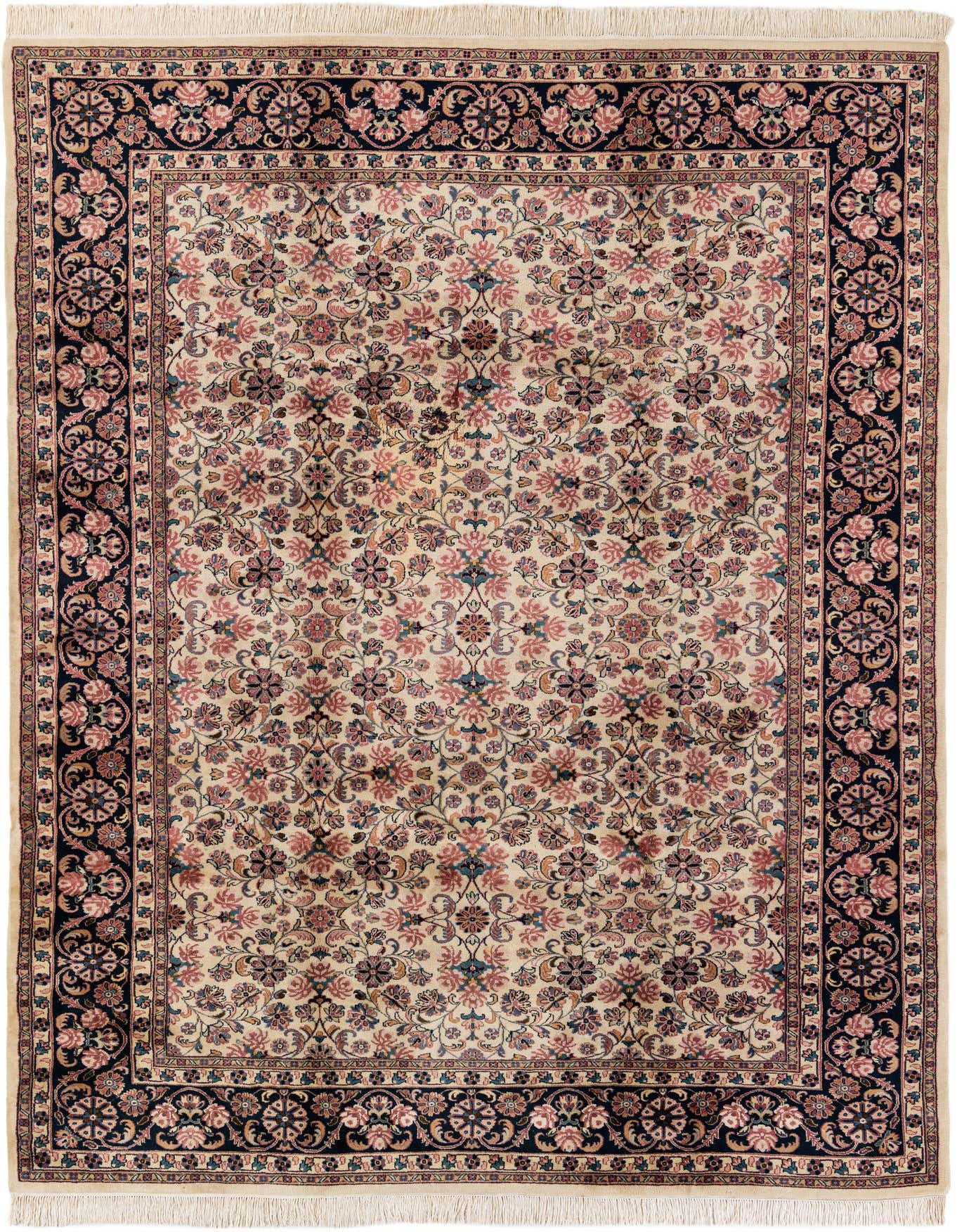 An 8x12 rectangular ivory Sarough rug with a traditional floral pattern and a dark navy border, made of wool.