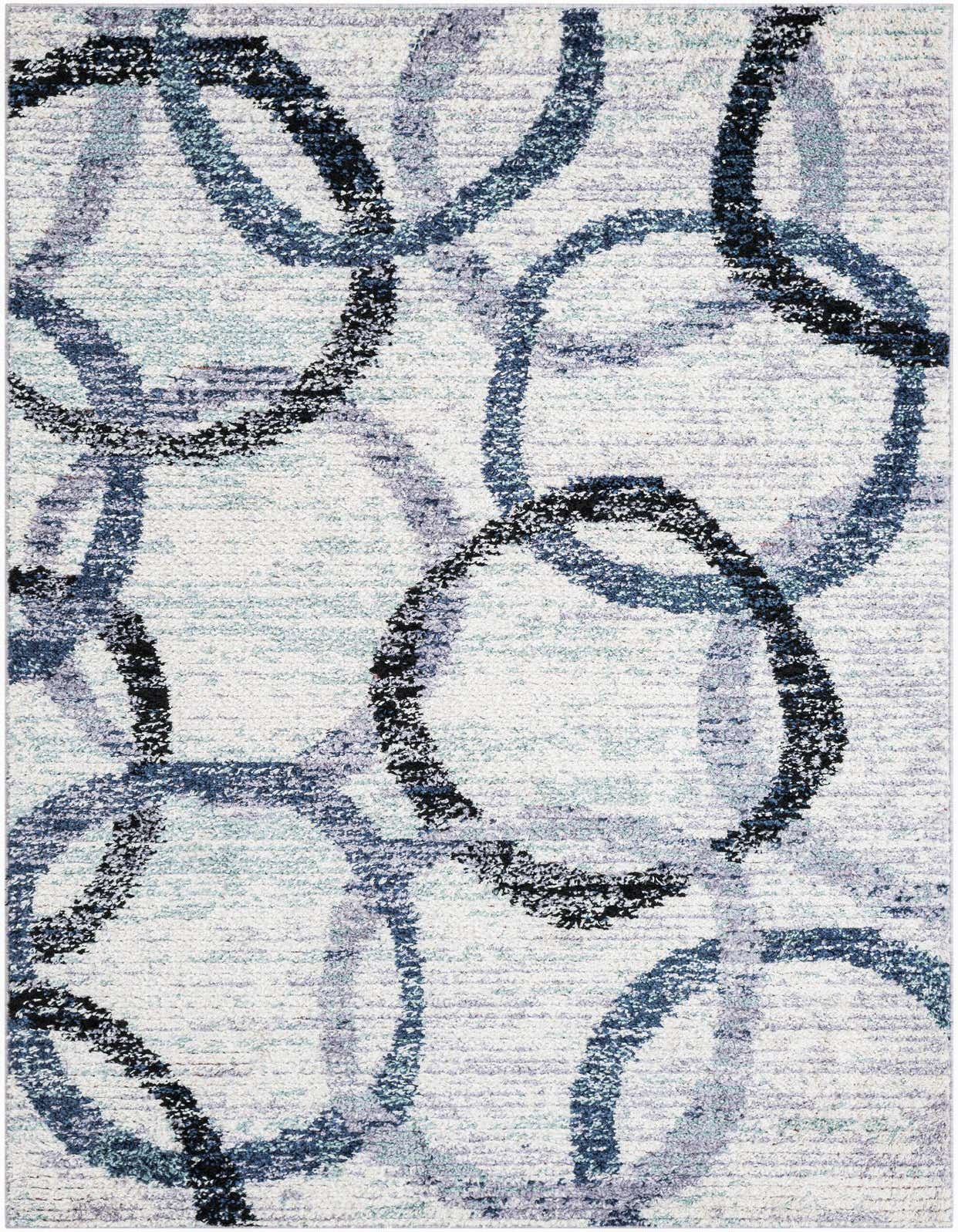 A 5x8 rectangular ivory shag rug with an abstract pattern of overlapping blue, black, and gray circles.