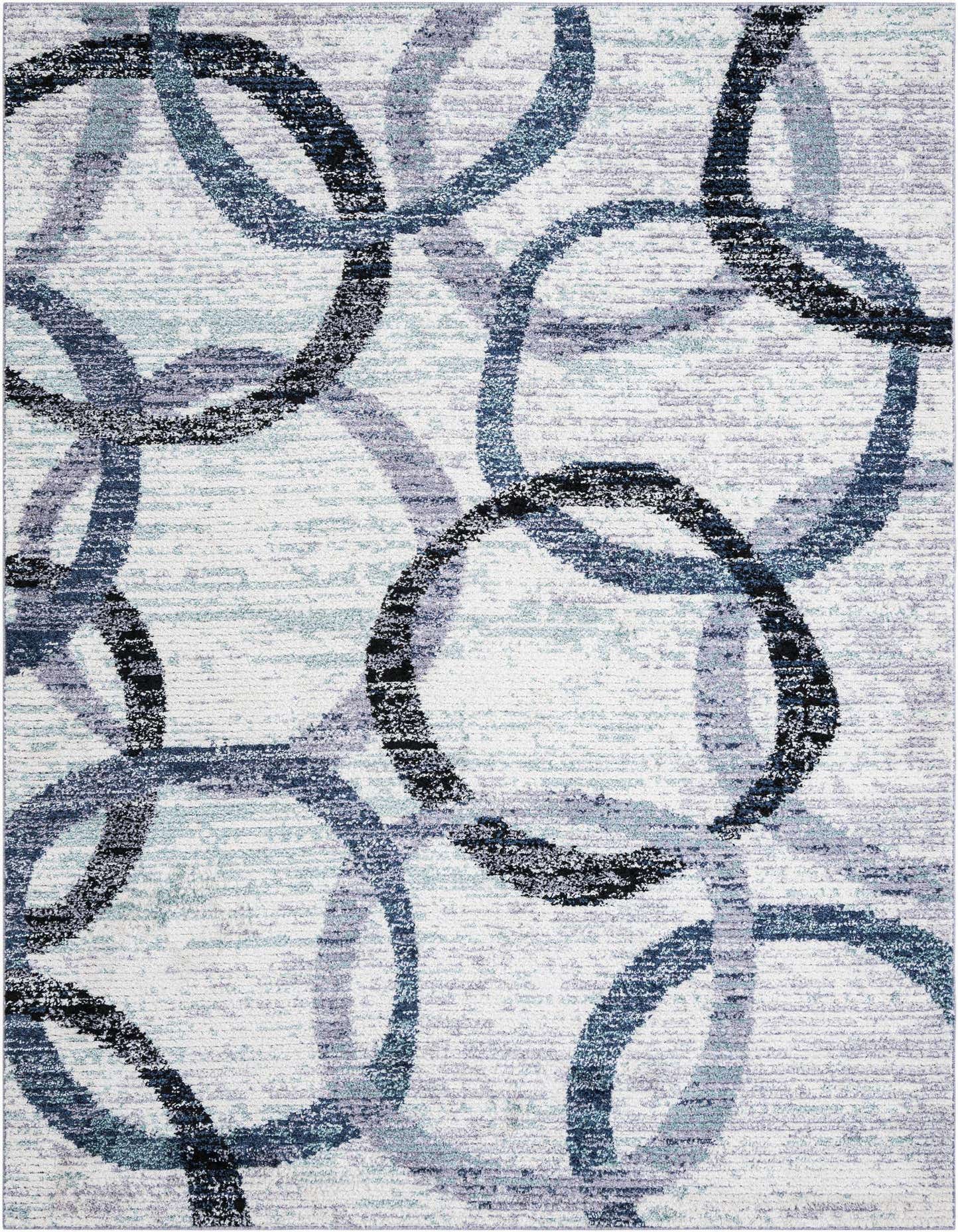 A 9x12 rectangular ivory shag rug with an abstract pattern of overlapping blue, grey, and black circles.