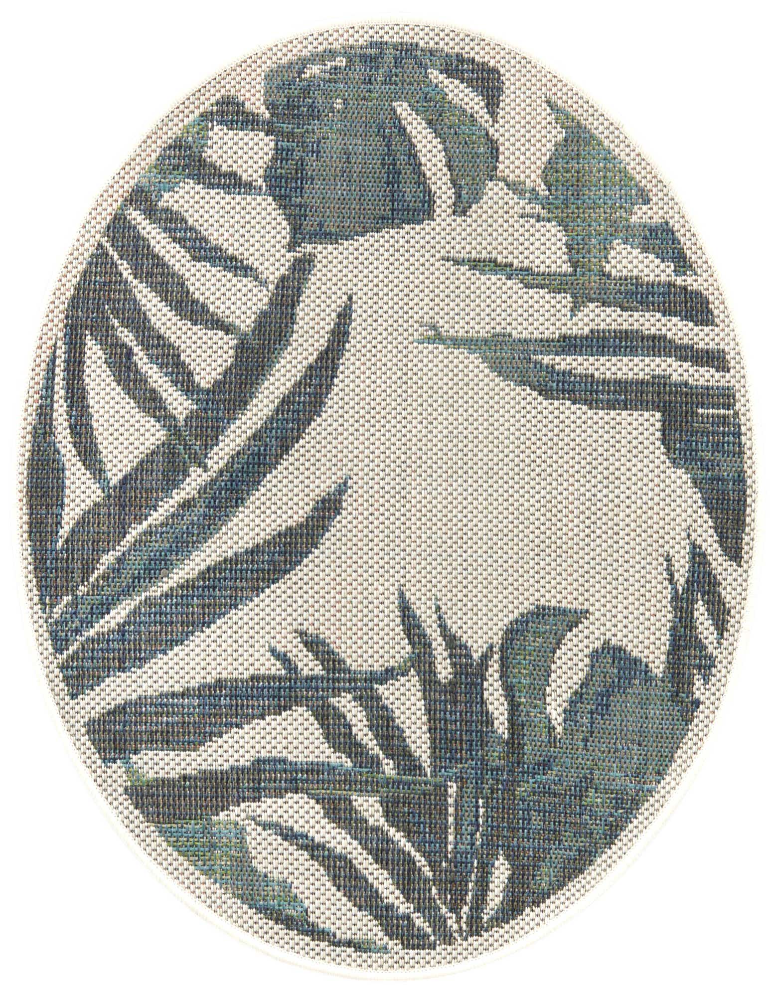 A round ivory and cream flatweave rug with a modern botanical pattern of blue and green palm leaves, suitable for indoor or outdoor use.