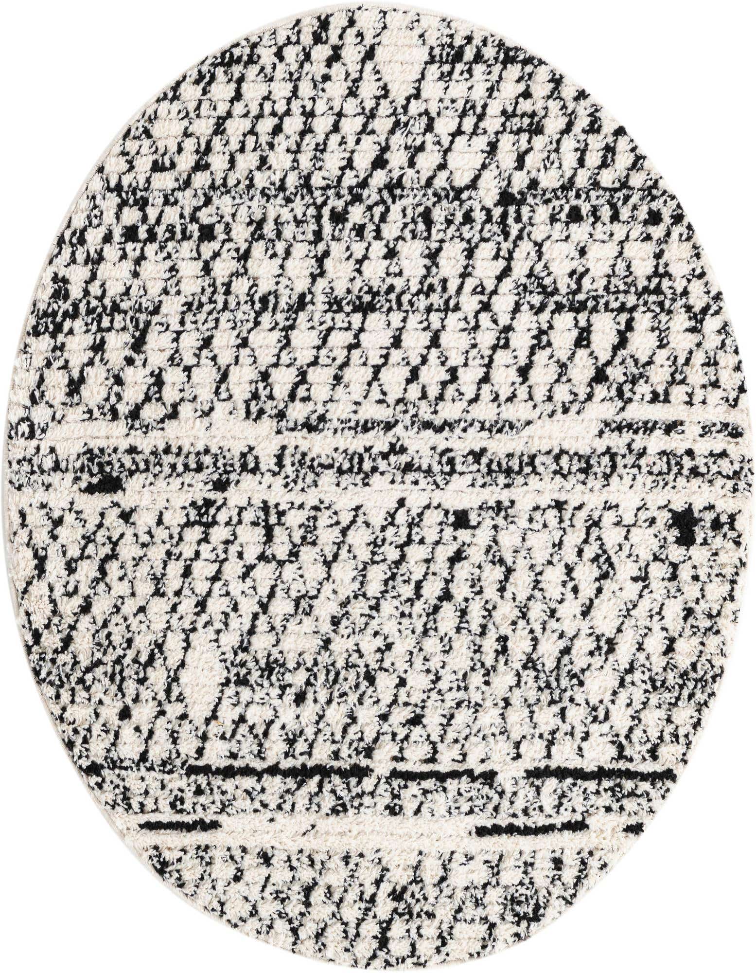 A round ivory and black shag rug featuring a textured trellis and tribal pattern, ideal for an indoor space.