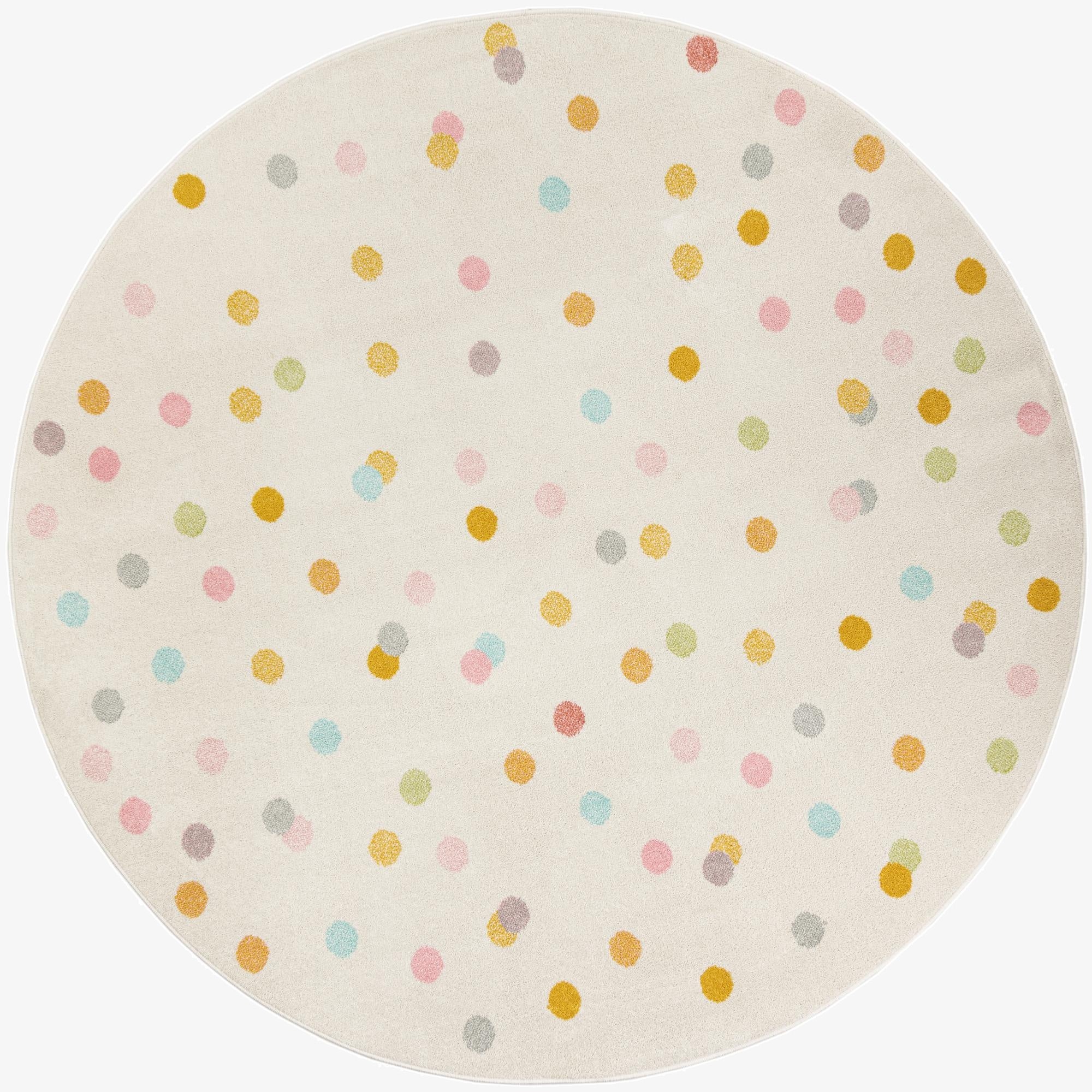 A round ivory rug with a playful, scattered polka dot pattern in various pastel colors like pink, yellow, blue, and green.