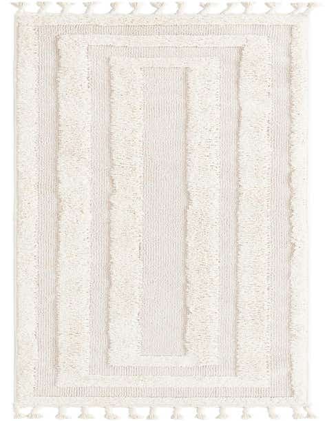 A 10 ft runner rug in ivory and cream with a textured geometric pattern and decorative tassels.