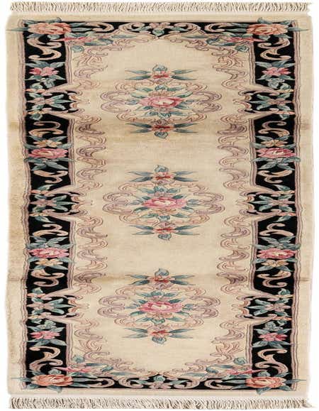 A 10 ft runner rug featuring a traditional Oriental floral medallion pattern in ivory, black, and pink, with fringe.