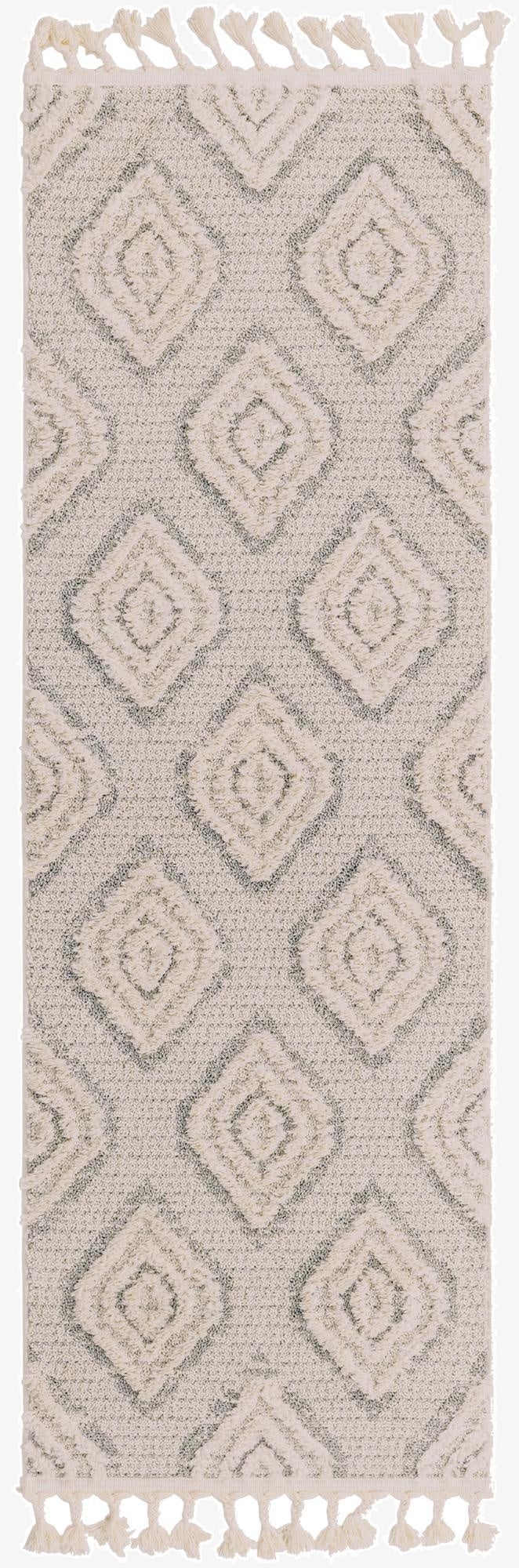A 6 ft runner rug with an ivory and cream tribal trellis pattern, featuring a textured pile and decorative tassels.