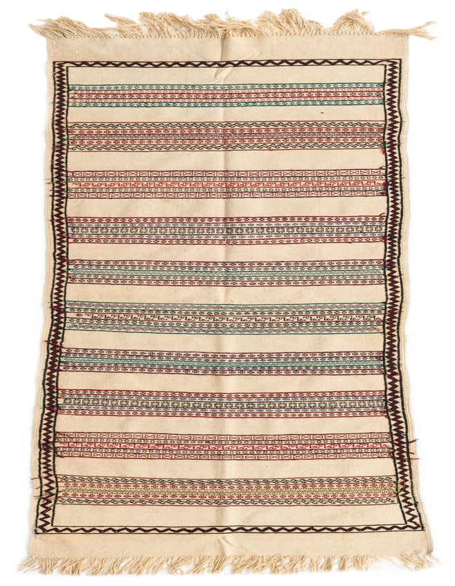 An 8 ft Kilim Fars runner rug in ivory with colorful tribal stripes and fringe, ideal for a hallway.
