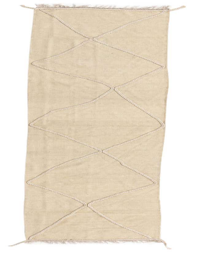 A 10 ft runner rug in ivory wool with a modern tribal diamond pattern created by textured braids, ideal for a hallway.