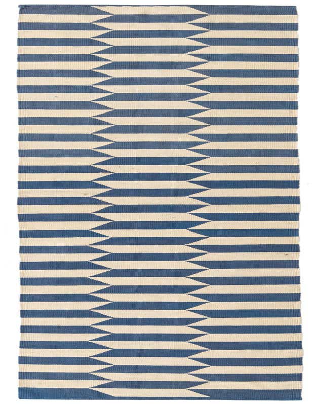 A 10 ft runner rug with a modern tribal pattern in alternating horizontal stripes of cream and deep blue, creating a zigzag effect.