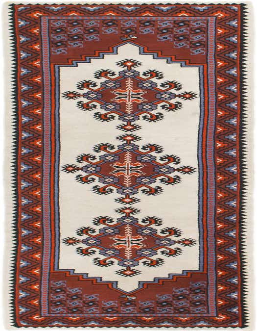 A long 11 ft ivory runner rug with a central red, blue, and black tribal medallion pattern, ideal for a hallway.