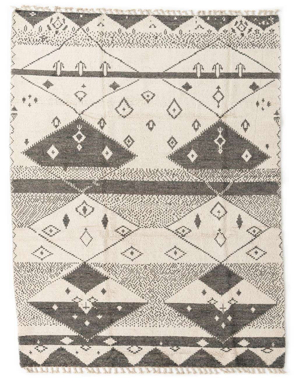 A 12 ft runner rug with a tribal pattern in ivory and charcoal gray, featuring geometric shapes and diamond motifs.