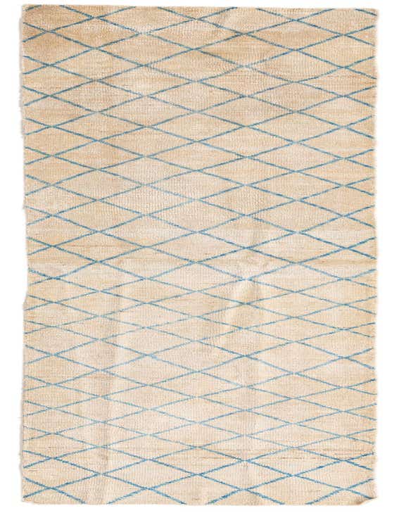 A long, rectangular ivory wool runner rug with a blue tribal diamond pattern, ideal for a hallway.