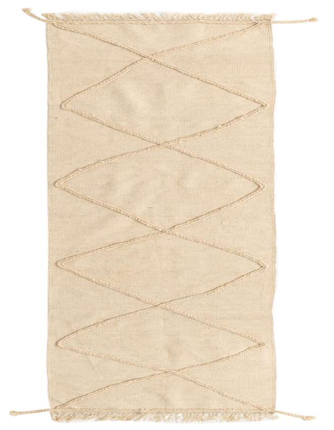 A 10 ft runner rug in ivory wool with a tribal diamond pattern made from braided shag lines, suitable for a hallway.