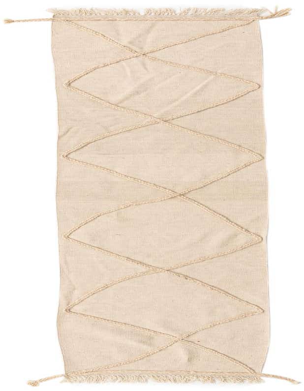A 10 ft runner rug in ivory wool, featuring a modern tribal diamond pattern and fringed ends.