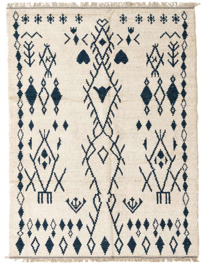A 13 ft runner rug with a cream shag pile and a modern tribal pattern in deep navy blue, featuring abstract diamonds and geometric shapes.