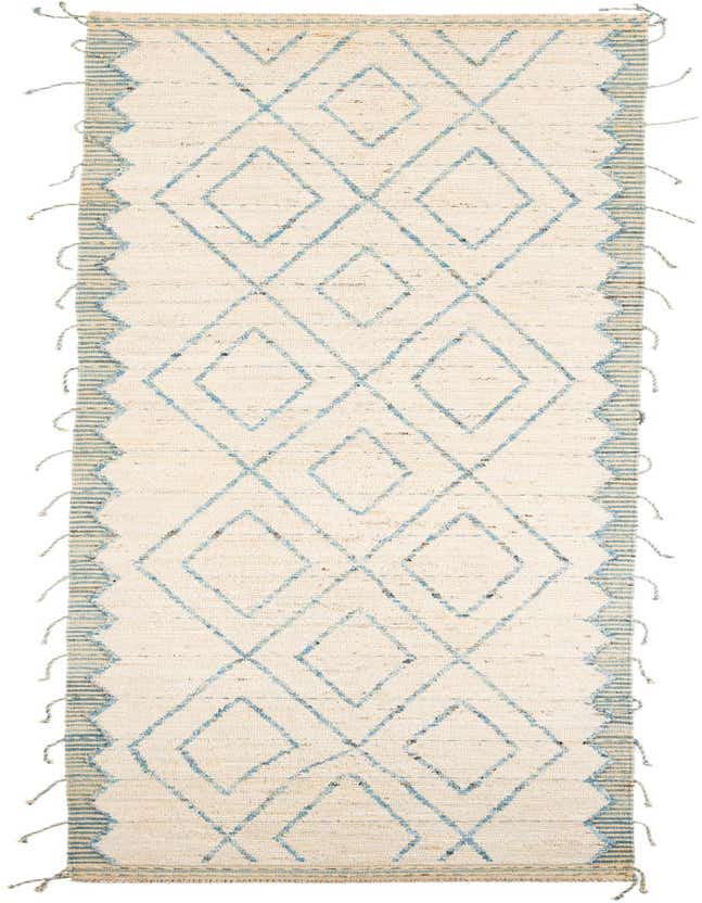 A 13 ft runner rug with an ivory and cream shag pile, featuring a blue tribal diamond pattern and striped borders.
