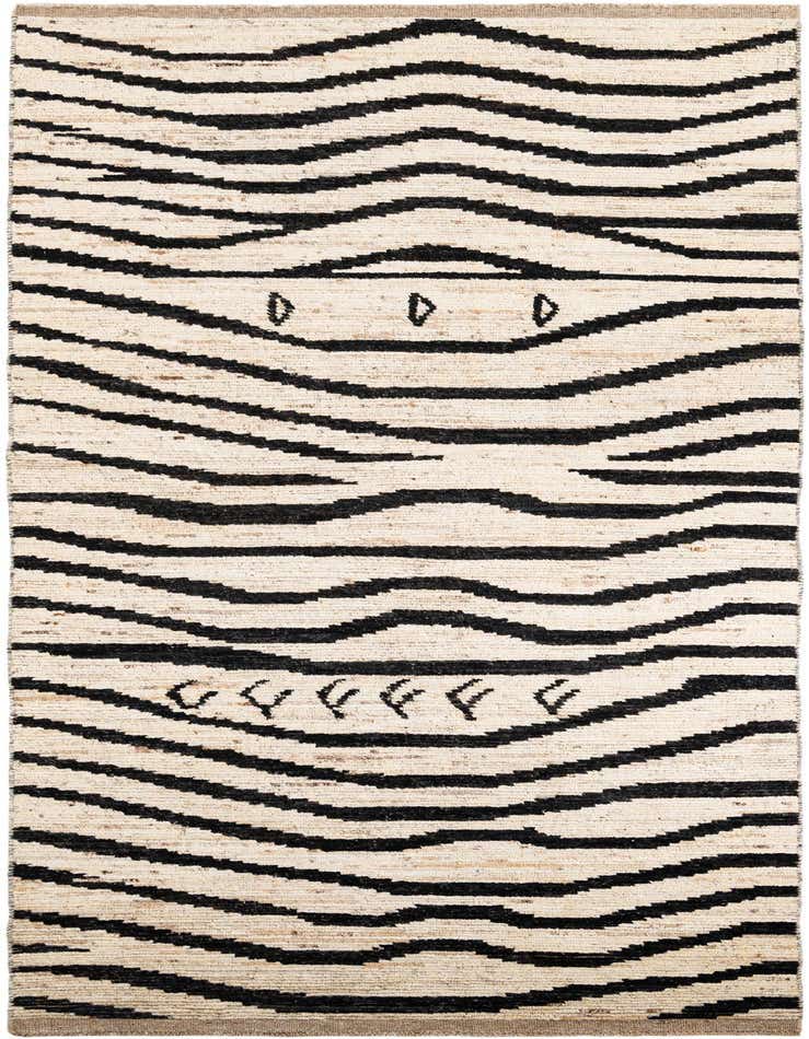 A 14 ft runner rug with a tribal pattern featuring thick, wavy black lines on an ivory and cream shag background, ideal for a hallway.