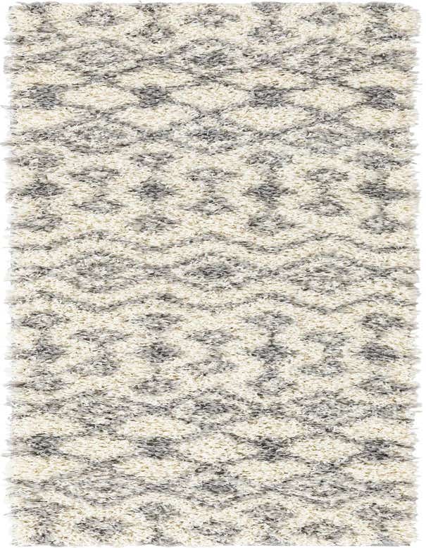 A 7 ft runner rug in ivory and gray with a tribal trellis pattern, featuring a soft shag pile.