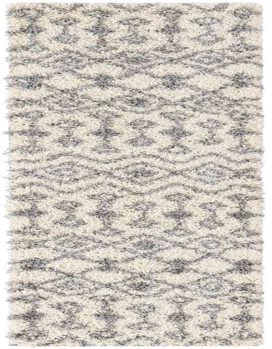 An 8 ft runner rug with a thick shag pile, featuring a modern tribal pattern in ivory and gray.