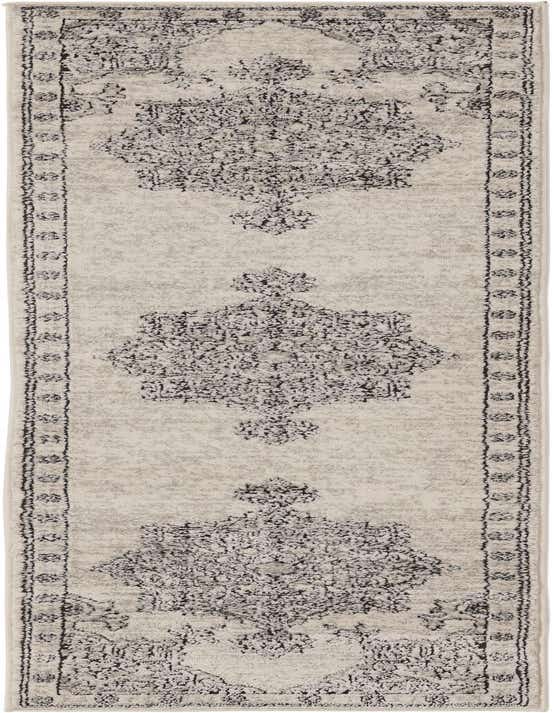 An 8 ft runner rug in ivory and cream with a distressed traditional medallion pattern, ideal for a hallway.