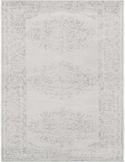A 10 ft runner rug from the Oxford collection, featuring a faded ivory and cream traditional medallion pattern.